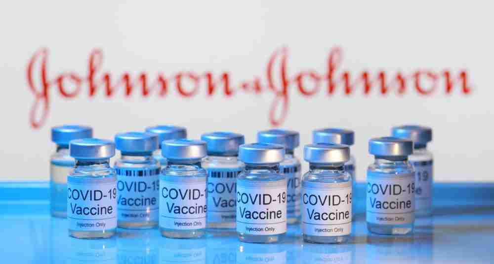 Soft focus image of Covid-19 vaccine injection vials against Johnson & Johnson (JJ) logo. JJ is an American multinational corporation that develops pharmaceuticals. PENANG, MALAYSIA – 14 JAN 2021.
