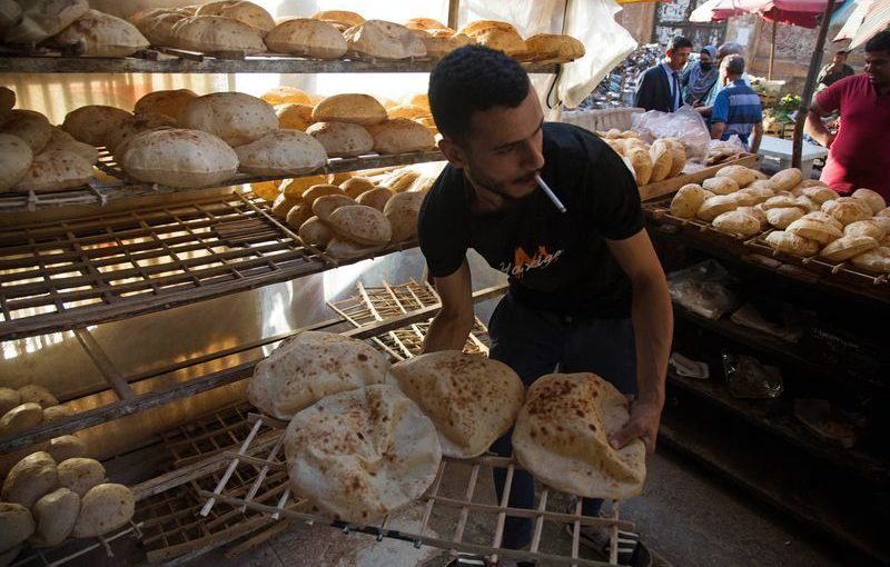 عامل يرتب خبزًا طازجًا للبيع في سوق المنيرة في القاهرة. الصورة: اسلام صفوت، لبلومبيرغ